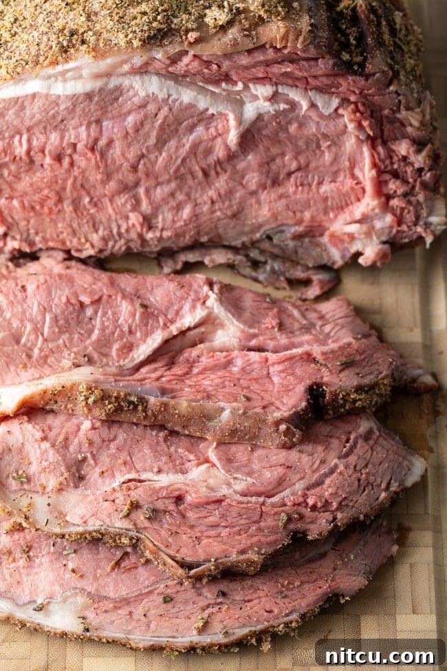 Perfectly cut smoked beef prime rib with au jus, made in a Traeger smoker