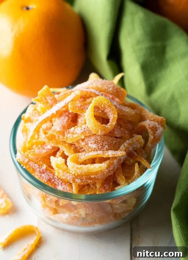 Small glass bowl showcasing the finished easy candied orange peel recipe, ready to be served or gifted.