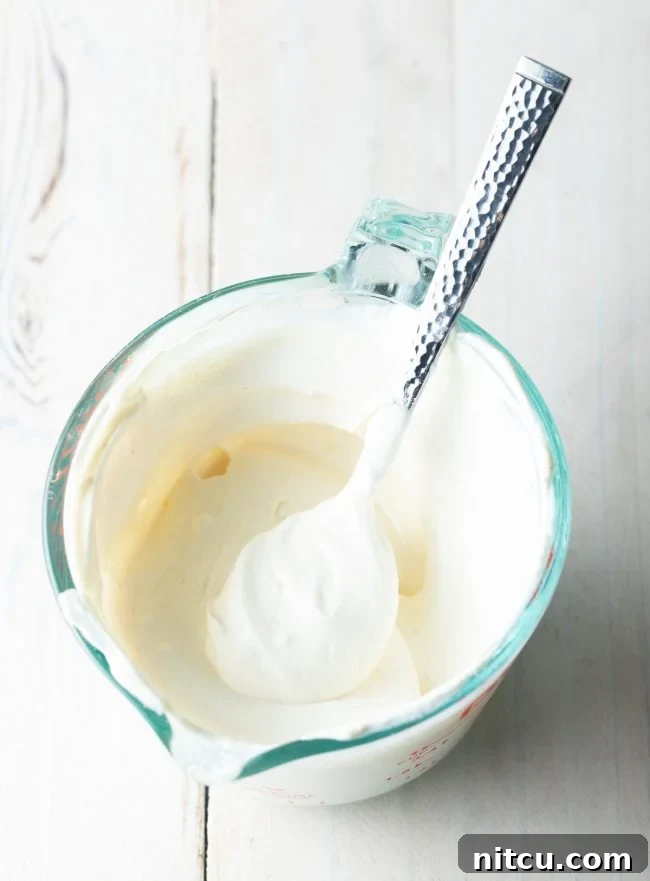 A bowl of sour cream, ready to be incorporated into the Hungarian Mushroom Soup.