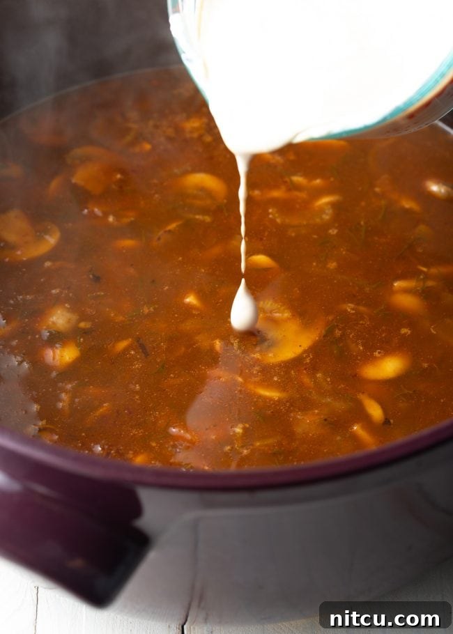 A serving of creamy, rich vegan mushroom soup, ready to be enjoyed.