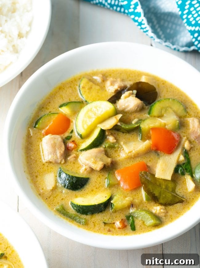 A pristine white bowl generously filled with creamy Instant Pot Green Curry, invitingly presented.
