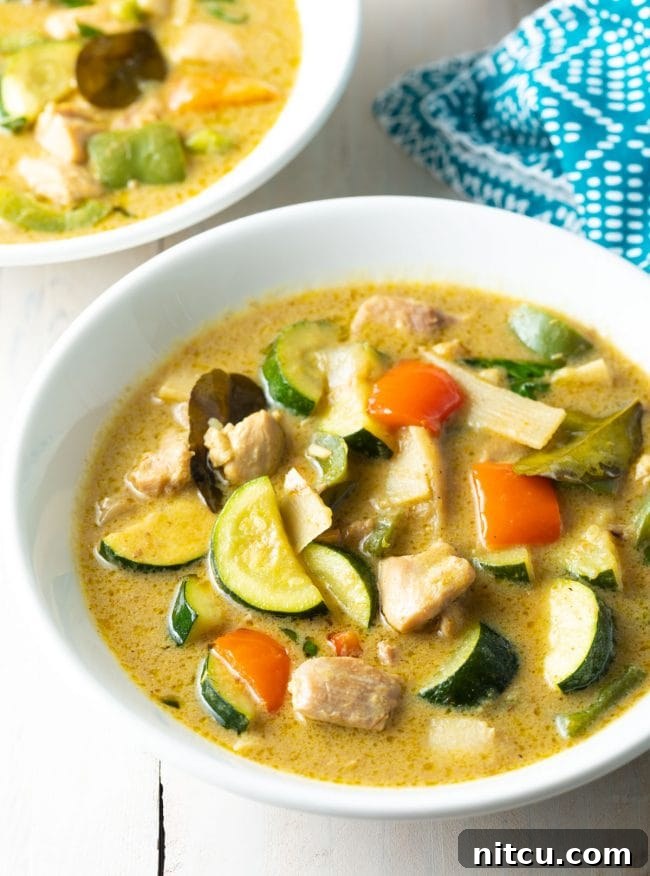 A close-up view of the rich and creamy texture of Instant Pot Green Curry, garnished with fresh herbs.