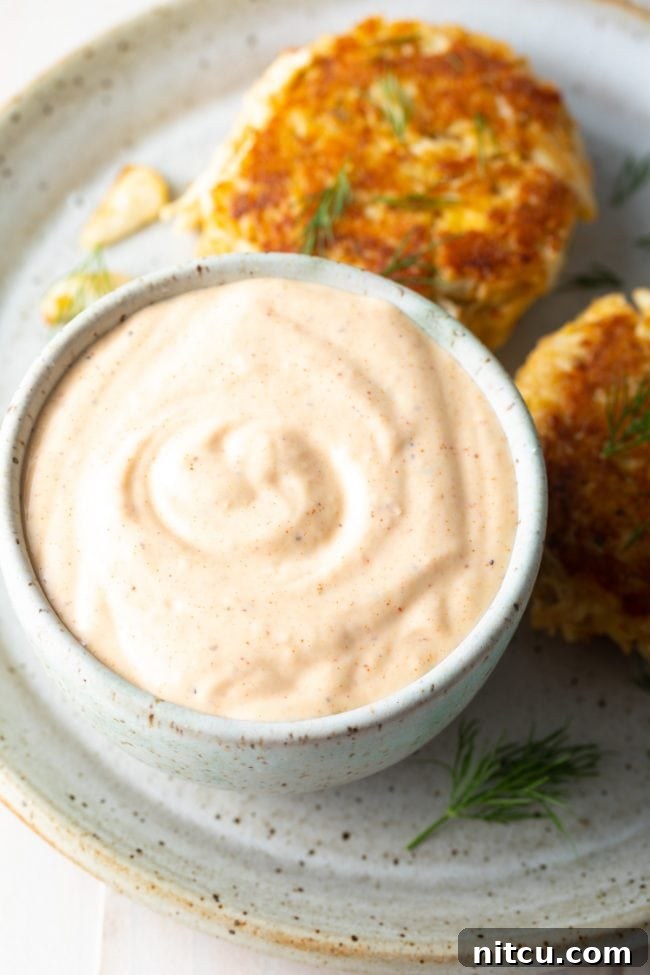 Baked crab cakes served with remoulade on the side.