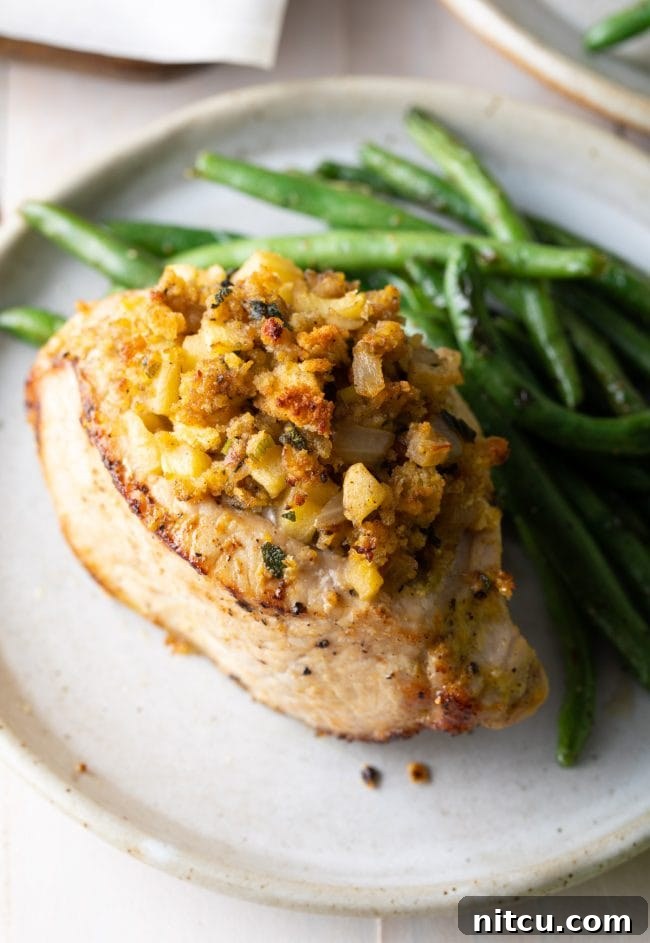 Side view of how to plate the stuffed pork chops with a side of green beans with it