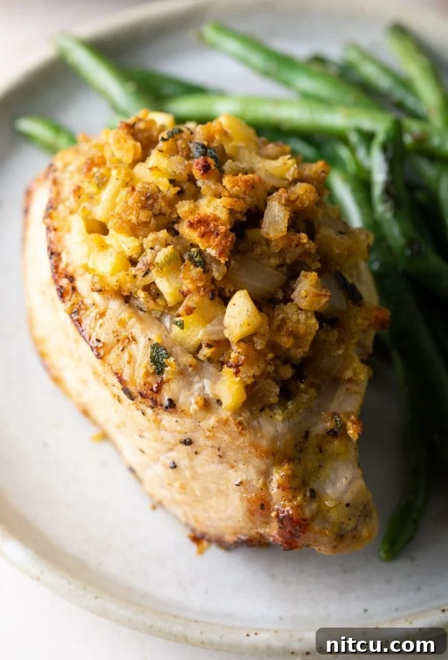 Top shot of this stuffed pork chops recipe with apple and cornbread filling and a side of green beans
