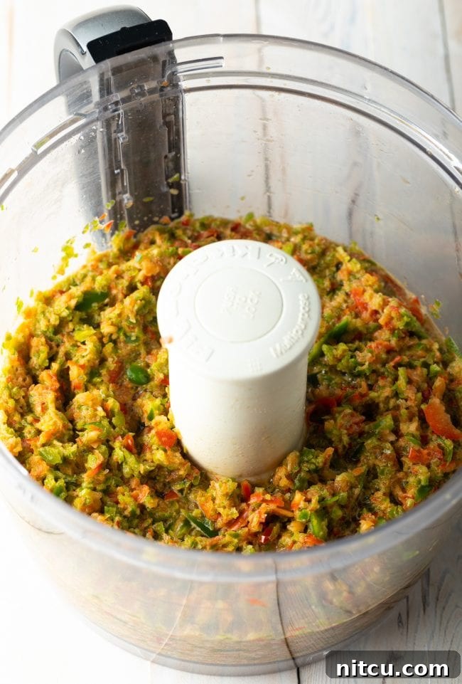 Blended peppers in the food processor, forming a paste.