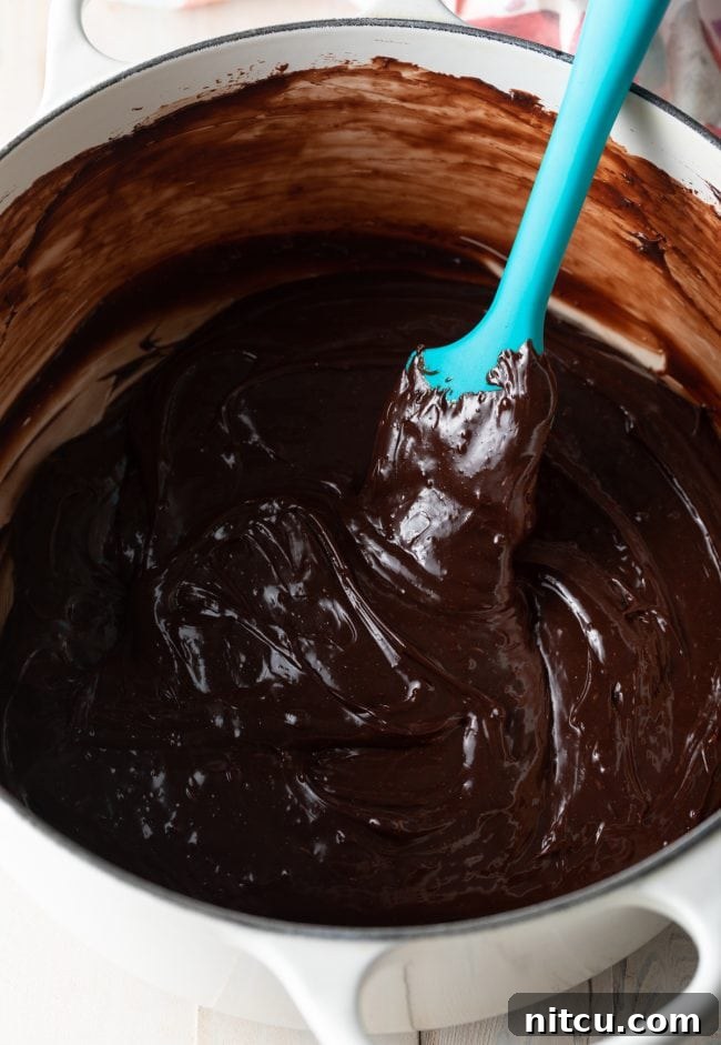 The brigadeiro mixture cooking in a pot, thickening into a rich chocolate fudge.