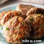 Slices of an easy homemade breakfast sausage recipe lined up in a circle on a blue plate.