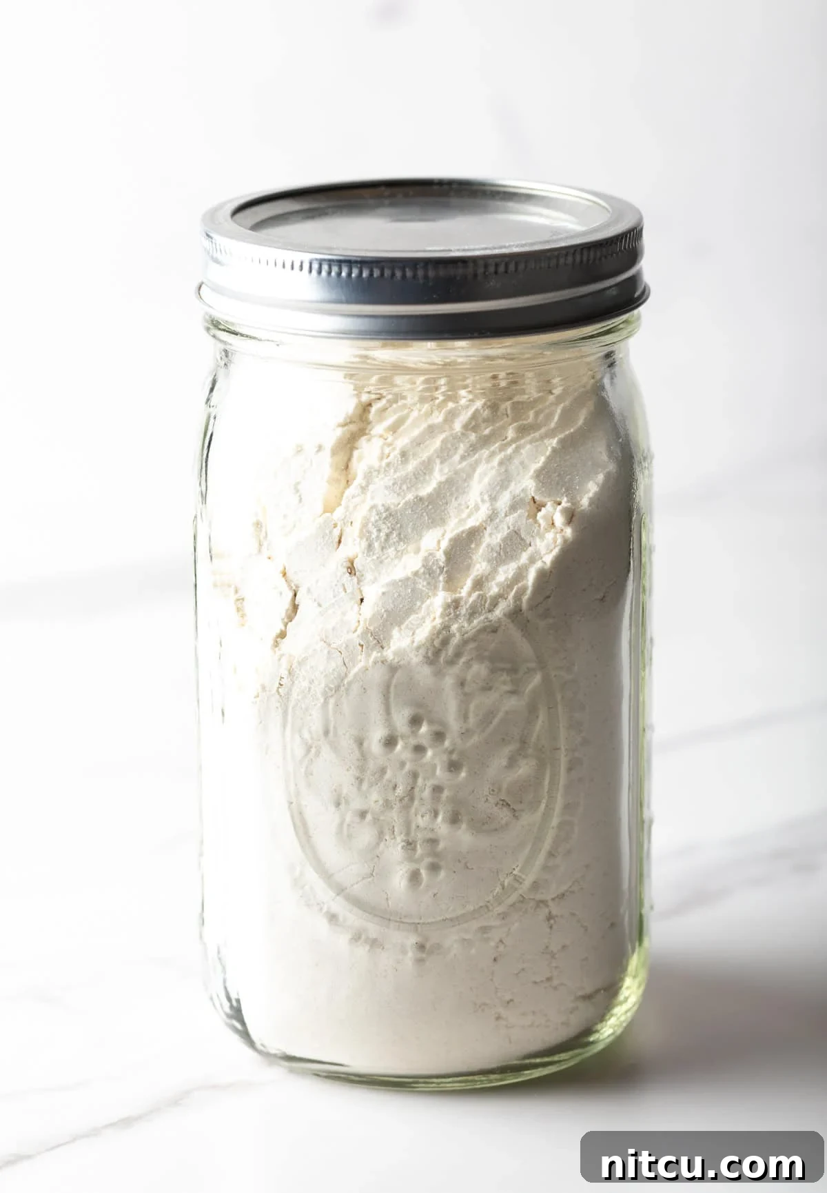 A mason jar filled with buttermilk pancake mix.